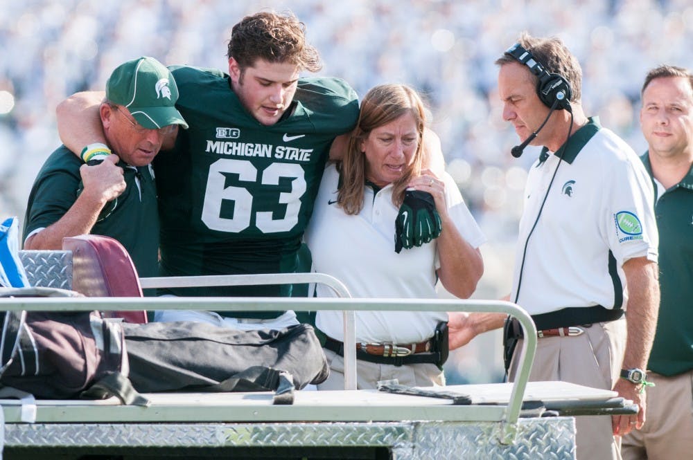 	<p>Sophomore center Travis Jackson is carried off the field during a game against Ohio State on Saturday at Spartan Stadium. Jackson was injured in the game and could miss the rest of the season. </p>