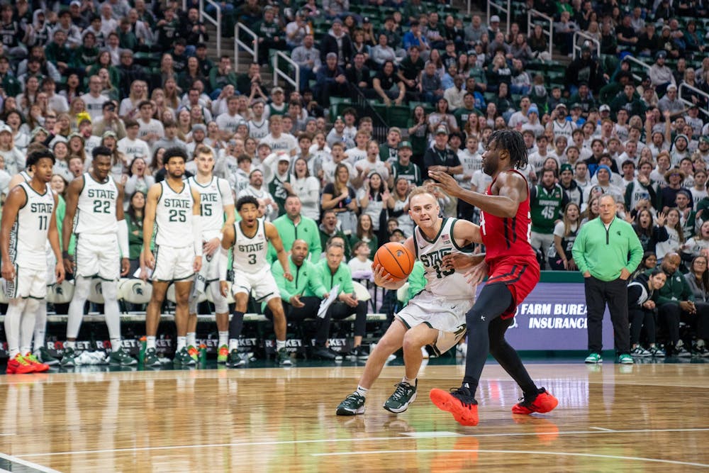 <p>Graduate student guard Steven Izzo (13) driving the ball during a game against Rutgers at the Breslin Student Event Center on Jan. 14, 2024. Izzo successfully drew a foul and completed the and-one by making the lay-up and subsequent free-throw attempt.</p>