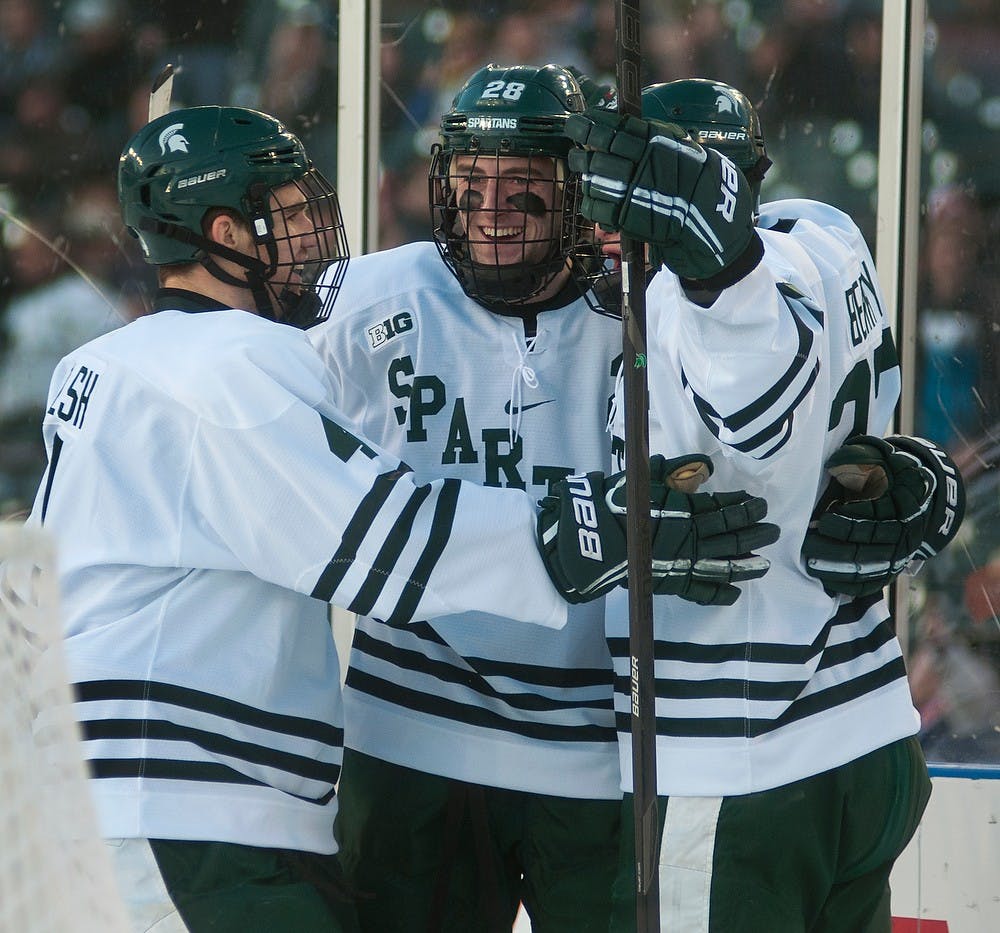 	<p>From left, sophomore defenseman Travis Walsh, freshman forward Thomas Ebbing, and junior forward Matt Berry celebrate the first Spartan goal during the Great Lakes Invitational consolation game against Michigan on Dec. 28, 2013, at Comerica Park in Detroit, Mich. The Spartans defeated the Wolverines, 3-0. Danyelle Morrow/The State News</p>