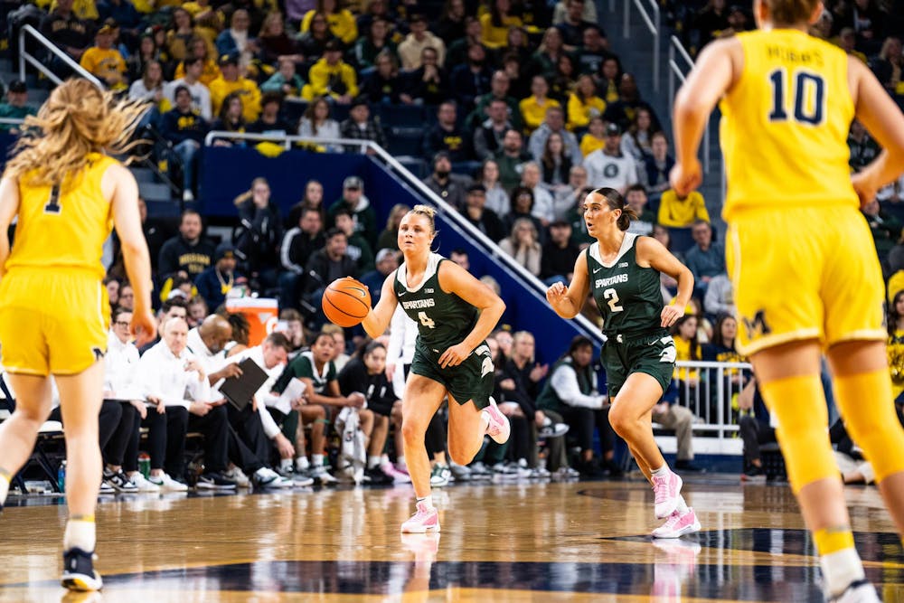 Michigan State sophomore guard No. 4 Theryn Hallock takes the ball down the court at the Crisler center in Ann Arbor, Feb. 18, 2024. Michigan State secured a season sweep of the rival Wolverines, breaking a two-game losing streak in the process.
