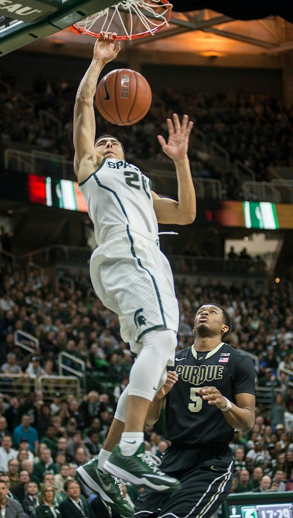 <p>Senior guard Travis Trice dunks the ball Mar. 4, 2015, during the game against Purdue at Breslin Center. At halftime, the Boilermakers were leading against the Spartans, 30-27. Emily Nagle/The State News</p>