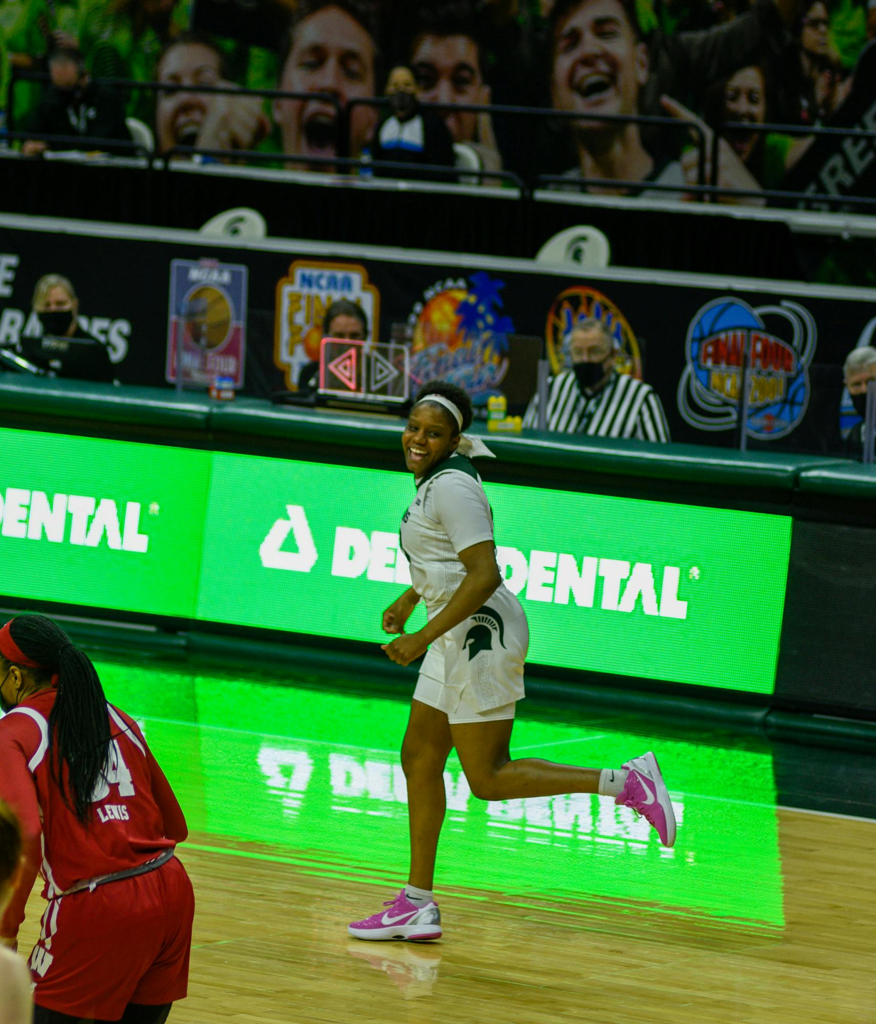 <p>Michigan State&#x27;s Janai Crooms (23) smiling while she ran down the court during the game against Wisconsin on Saturday, March 6, 2021.</p>