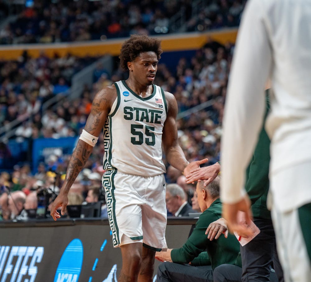 Junior forward Coen Carr (55) high-fives his teammates on the bench during the March Madness matchup against University of Louisville at the KeyBank Center in Buffalo, New York on March 21, 2026.