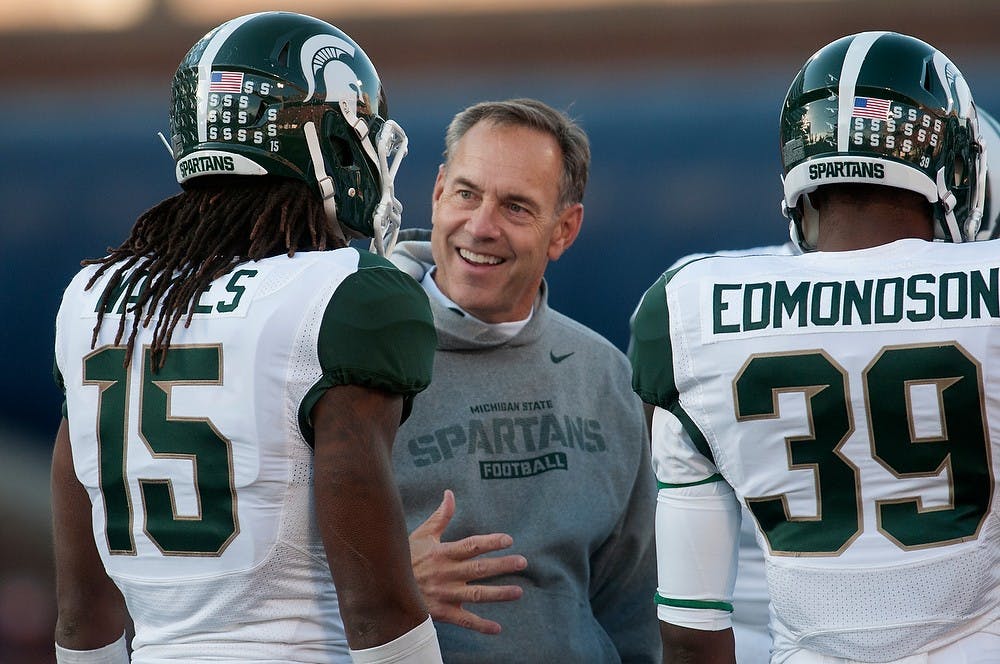 <p>Head coach Mark Dantonio talks to sophomore cornerback Trae Waynes during the game against Illinois on Oct. 26, 2013, at Memorial Stadium in Champaign, Ill. The Spartans defeated the Fighting Illini, 42-3. Julia Nagy/The State News.</p>