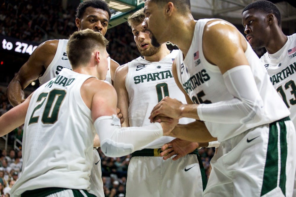 Spartans help senior guard  Matt McQuaid (20)  during the game against Rutgers on Feb. 20, 2019 a the Breslin Center. The Scarlet Knights led the Spartans, 32-25 at halftime.