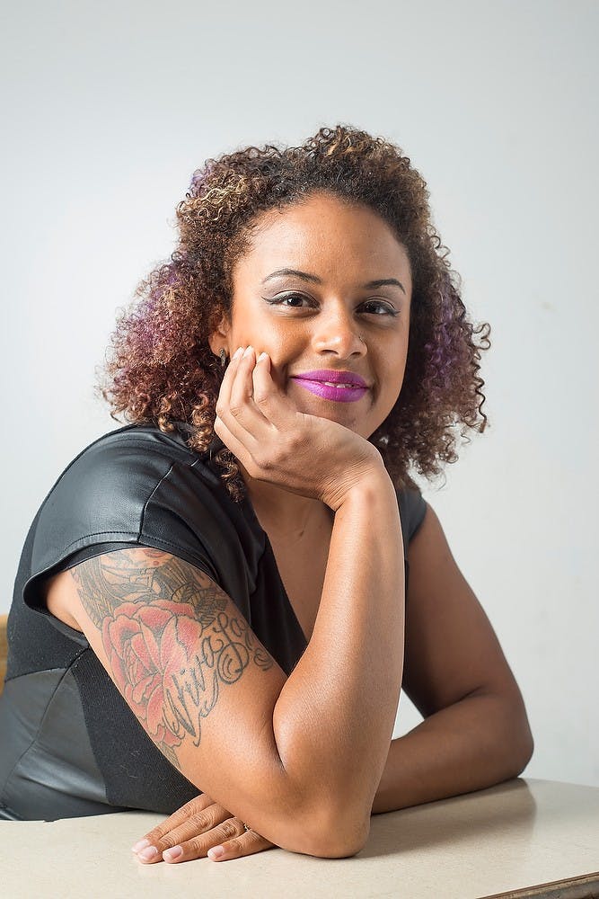 <p>Executive Director of The Firecracker Foundation Tashmica Torok poses for a portrait Sept. 10, 2014. Torok has six tattoos. Julia Nagy/The State News</p>