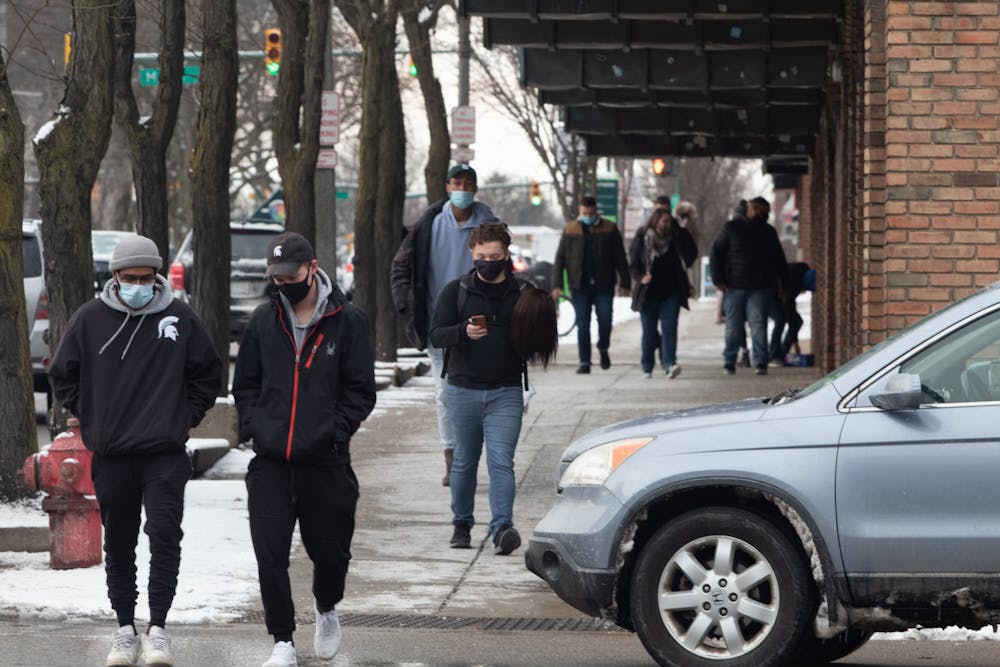 <p>People walking along Grand River Avenue on Jan. 20.</p>