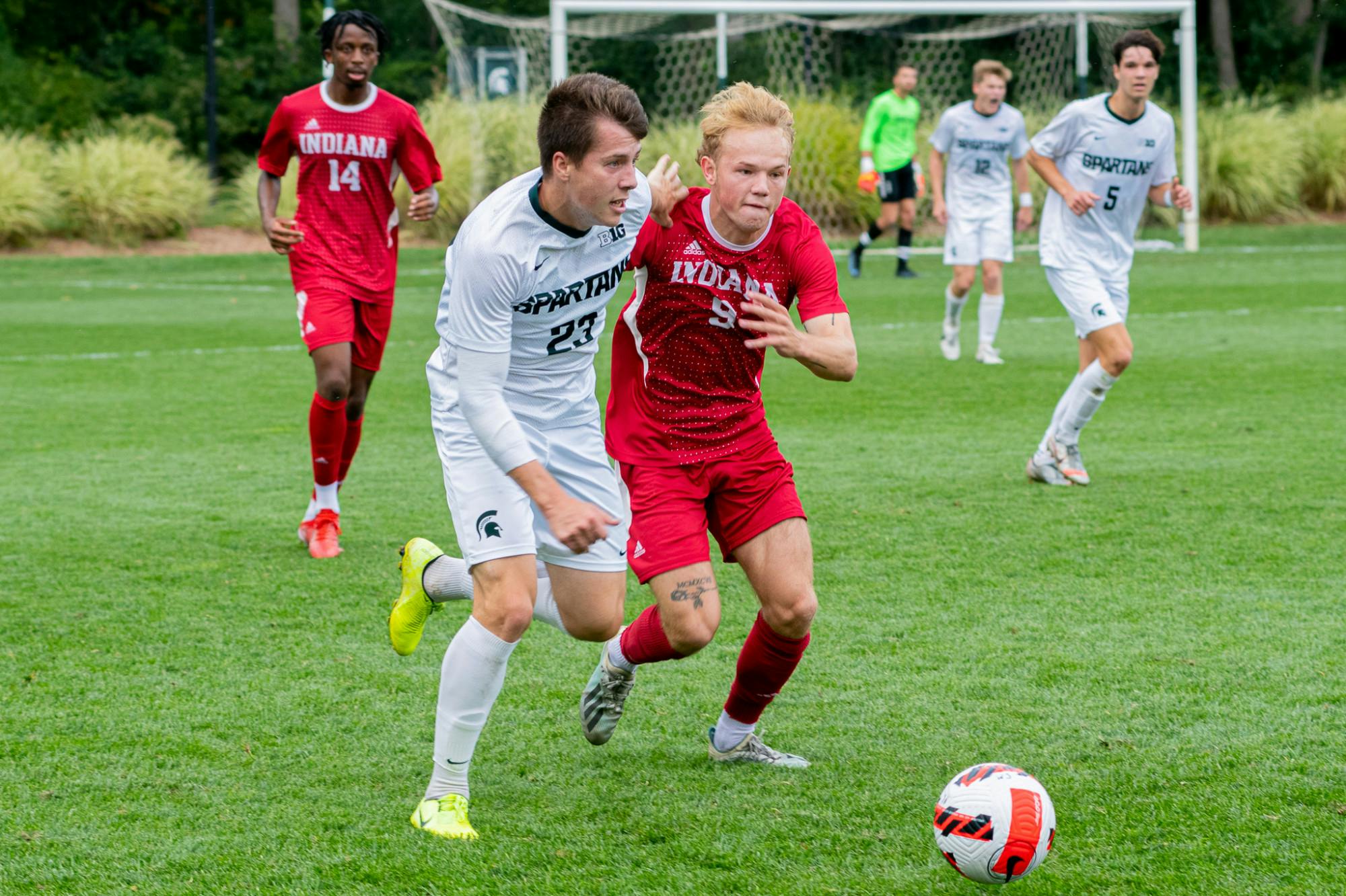 <p>Senior midfielder Luis Sala (23) intertwines arms with Indiana freshman forward Samuel Sarver (9), as they make a play on the ball. The Spartans faced off against the Hoosiers at DeMartin Field on Sept. 26, 2021.</p>