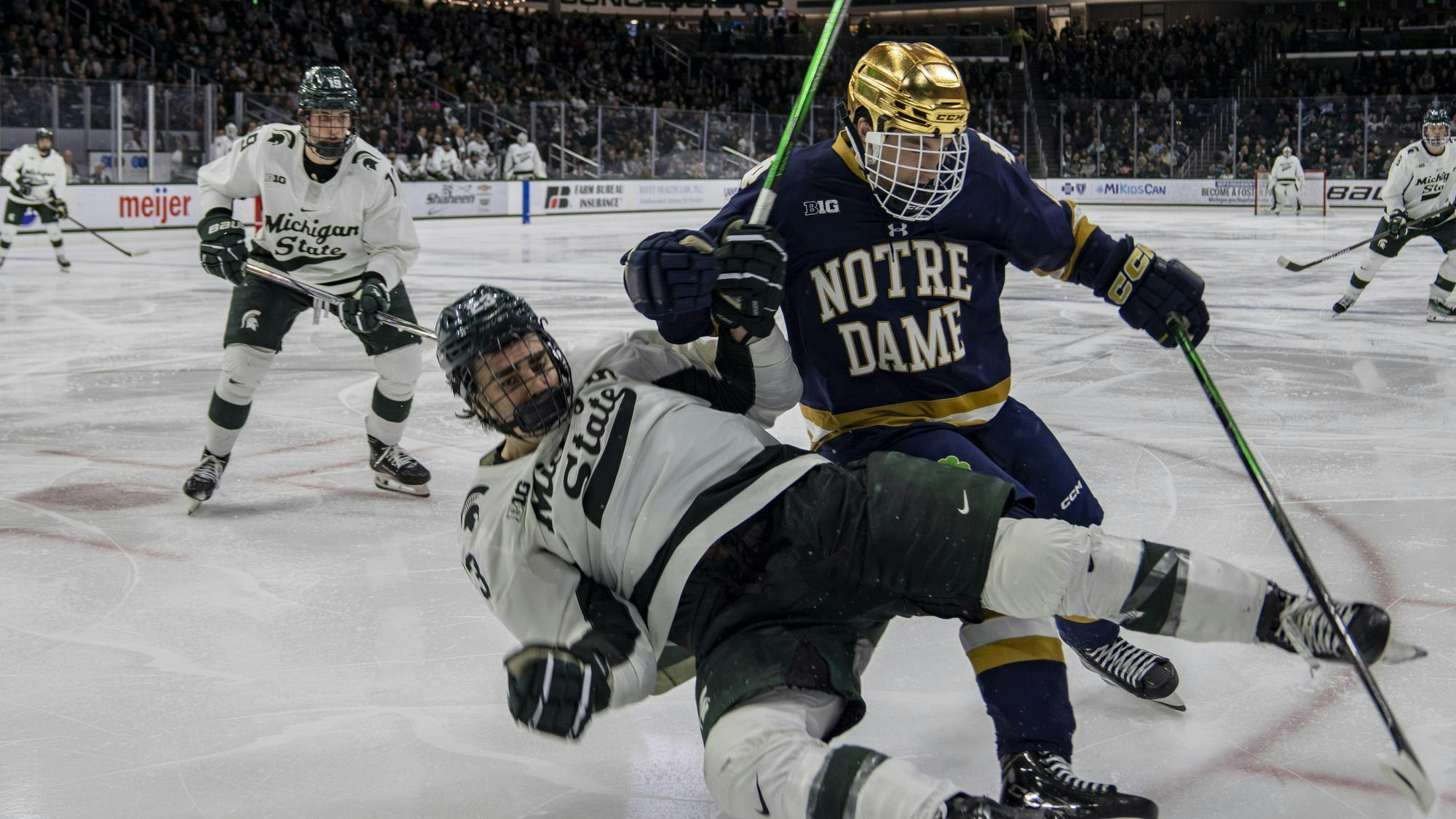 <p>MSU freshman forward Shane Vansaghi (23) gets checked by Notre Dame freshman forward Jack Larrigan (18) at Munn Ice Arena on Nov. 15, 2024. Michigan State took the win 8-3.</p>