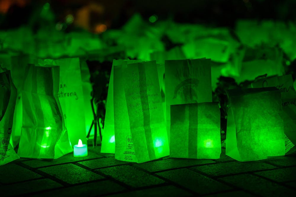 <p>Green-lit luminaries surround the Spartan Statue on Feb. 13, 2024. One year after the Michigan State University campus shooting, a remembrance ceremony was held to remember and reflect on the tragedy.</p>