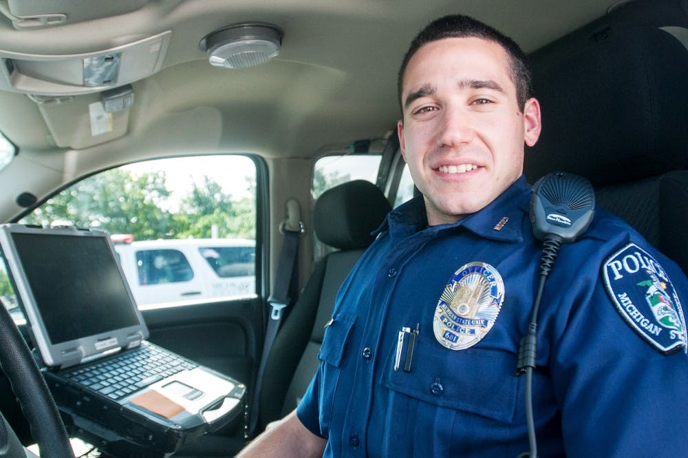 Newly inducted MSU police officer Sam Miller sits in a police car on June 5, 2012. Before becoming an officer, Miller worked as a Student Supervisor in the Homeland Security and Planning Division. Julia Nagy/The State News