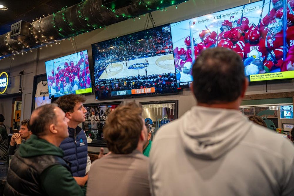 <p>MSU fans watch the Spartans face off against the Wisconsin Badgers in Lou and Harry's Bar and Grill in East Lansing, MI on March 28, 2026. The Spartans fell to the Badgers in overtime, 4-3.</p>