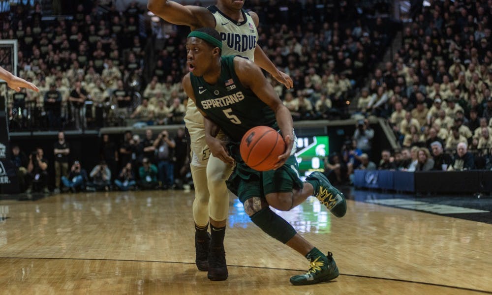 <p>Junior guard Cassius Winston (5) blows by Purdue's Nojel Eastern at Mackey Arena on Jan. 27, 2019. The Spartans fell to the Boilermakers, 73-63.</p>