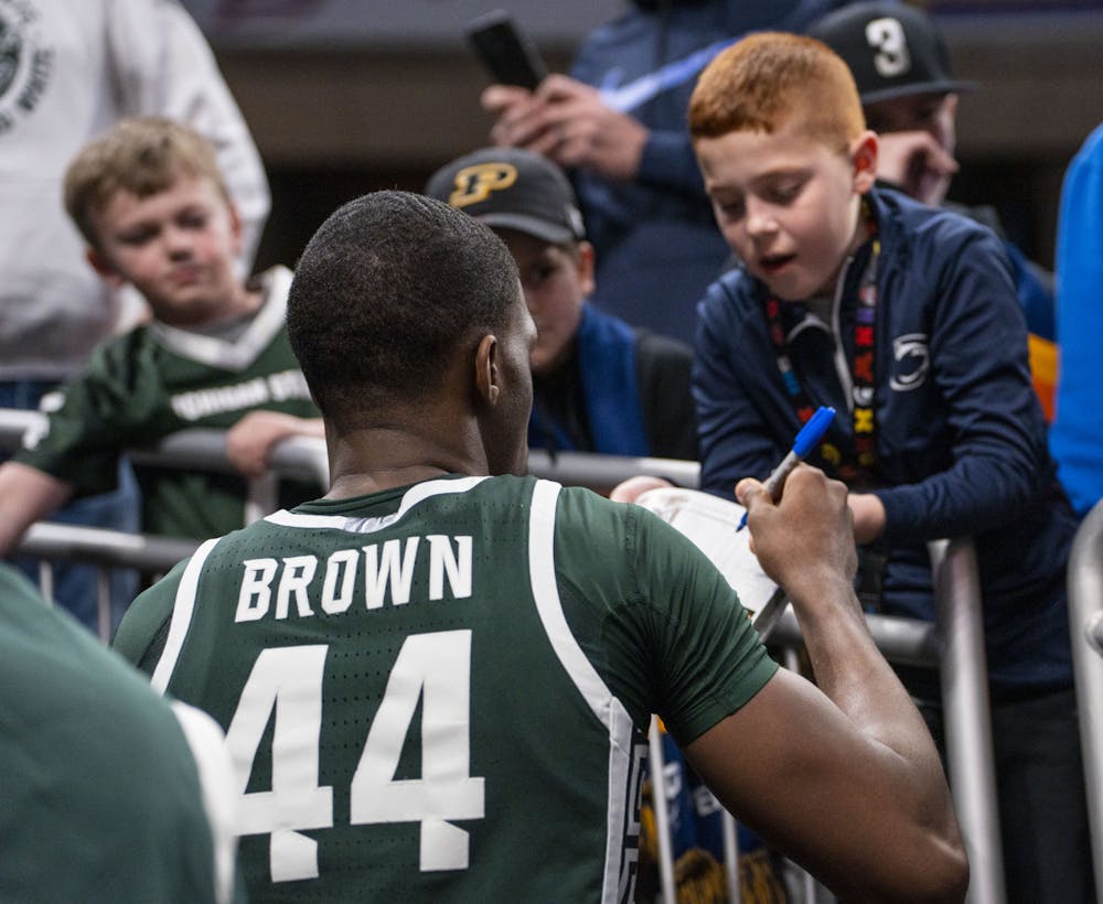 <p>Despite the loss, senior forward Gabe Brown (44) stops to sign an autograph for a young fan on his way out of the arena. Michigan State took on the Purdue Boilermakers in the semifinals of the B1G tournament but fell 75-70. - March 12, 2022</p>