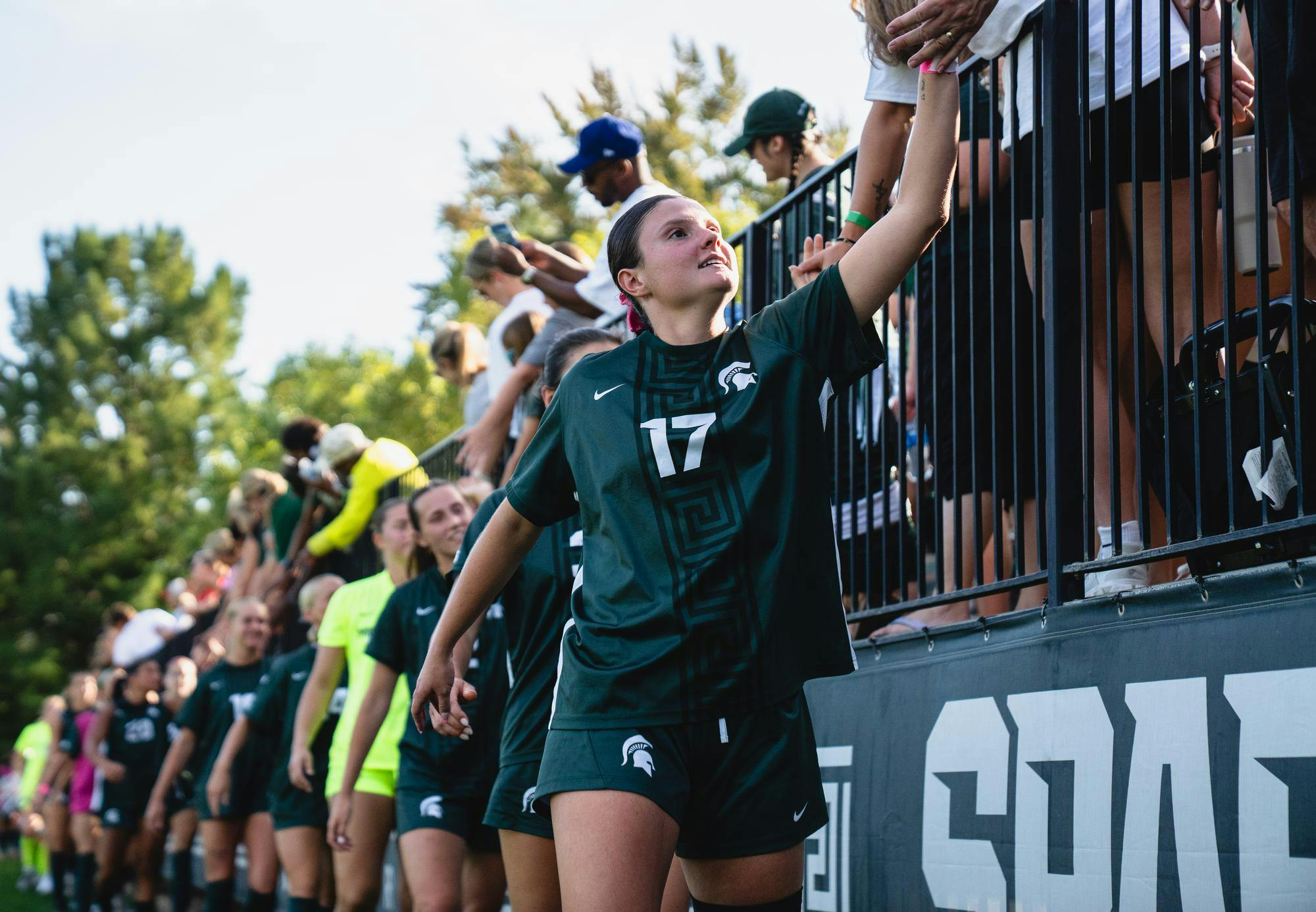 MSU senior defender Allie Mairn (17) gives fans hi-fives after the game at the DeMartin Stadium in East Lansing, MI on Oct. 4, 2025