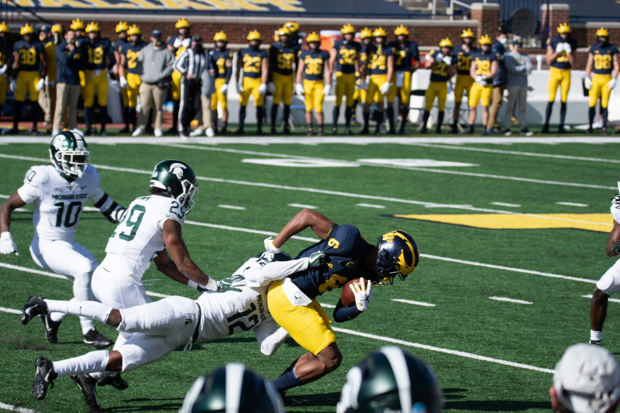 MSU cornerback, Chris Johnson (12),  tackles U of M wide reciever, Cornelius Johnson (6).