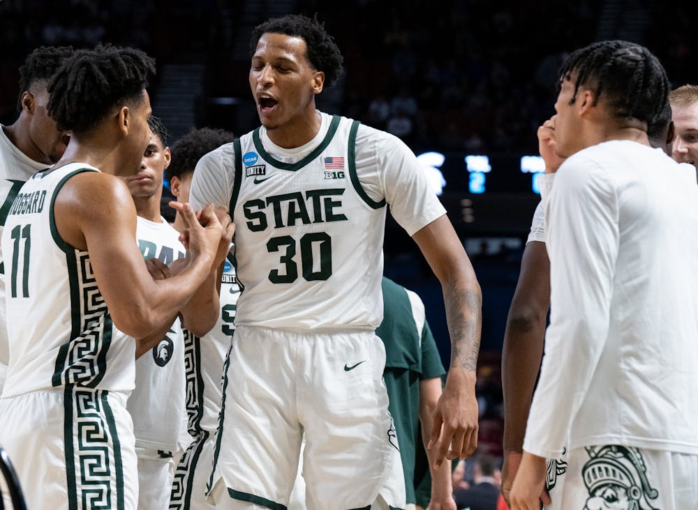 <p>Sophomore guard A.J. Hoggard (11) congratulates senior center Marcus Bingham Jr. (30) after coming off of the court during Michigan State&#x27;s win over the Davidson Wildcats on March 18, 2022.</p>