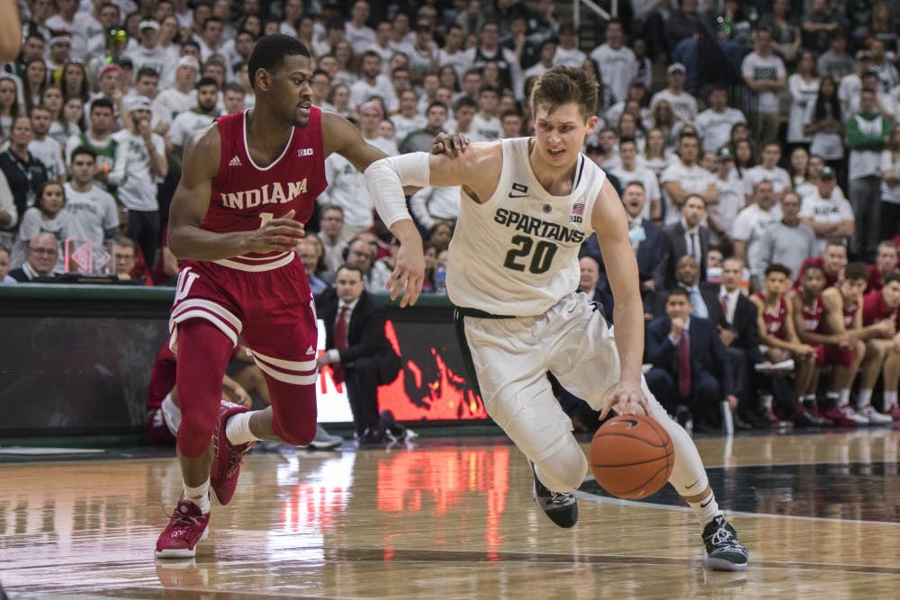 <p>Senior guard Matt McQuaid (20) drives to the net during the men's basketball game against Indiana on Feb. 2, 2019 at the Breslin Center. Michigan State lost to Indiana in overtime 79-75. Nic Antaya/The State News</p>