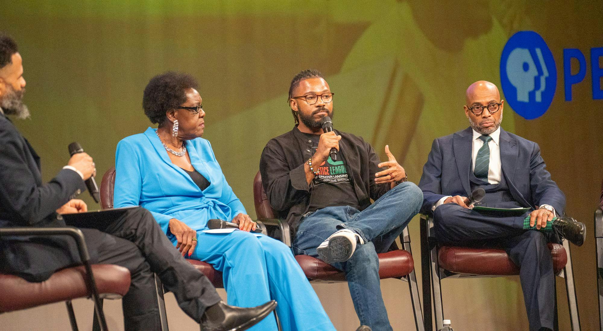 <p>Prince-Jerold Solace, Director of Congregational Life and Community Outreach at Lansing First Presbyterian Church, speaks on the panel after the showing of <em>The Cost of Inheritance</em> hosted by WKAR at the WKAR Studios on Jan. 18, 2024. </p>