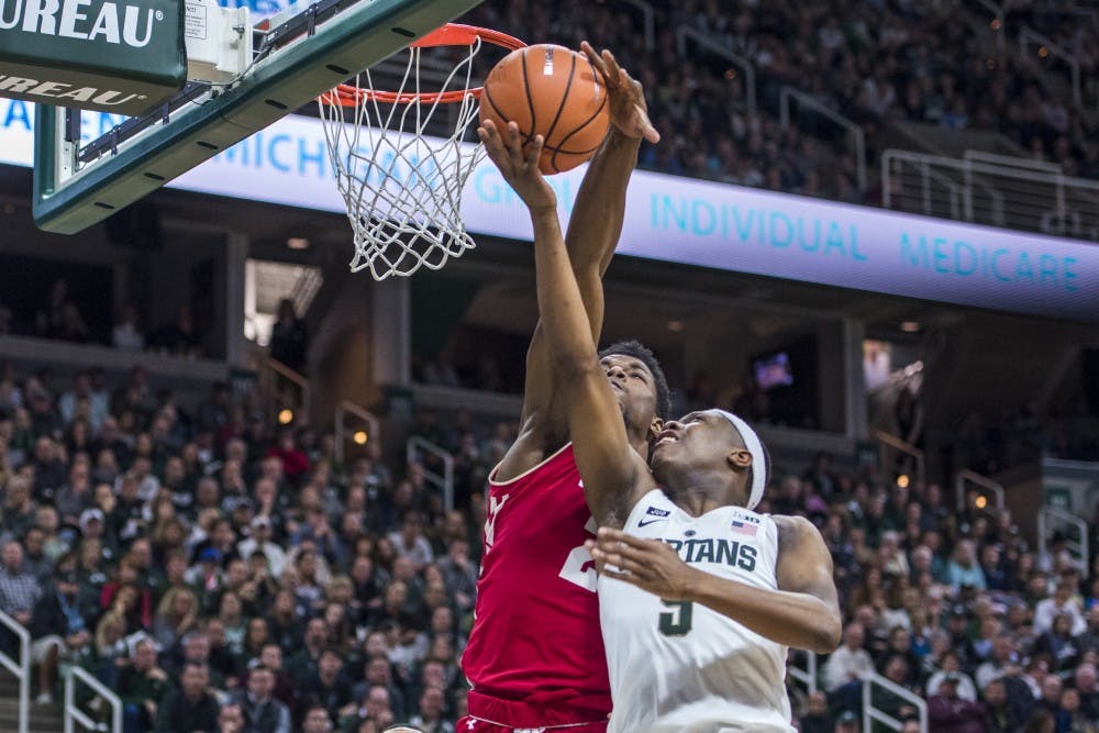 Sophomore guard Cassius Winston (5) goes for a lay up and is blocked by Wisconsin guard Khalil Iverson (21) during the second half of the men's basketball game against Wisconsin on Jan. 26, 2018 at Breslin Center. The Spartans defeated the Badgers, 76-61. (Nic Antaya | The State News)
