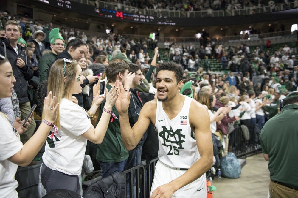 Sophomore forward Kenny Goins high fives fans  after the men's basketball game against the University of Michigan on Jan. 29, 2017 at Breslin Center. The Spartans defeated the Wolverines, 70-62.