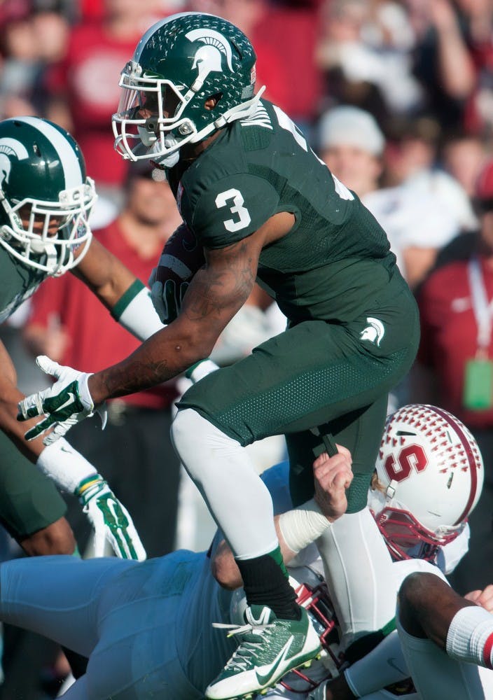 	<p>Stanford tight end Charlie Hopkins tackles sophomore wide receiver Macgarrett Kings Jr. during 100th Rose Bowl game Jan. 1, 2014, in Pasadena, Calif. The Spartans defeated the Cardinal, 24-20. Julia Nagy/The State News</p>