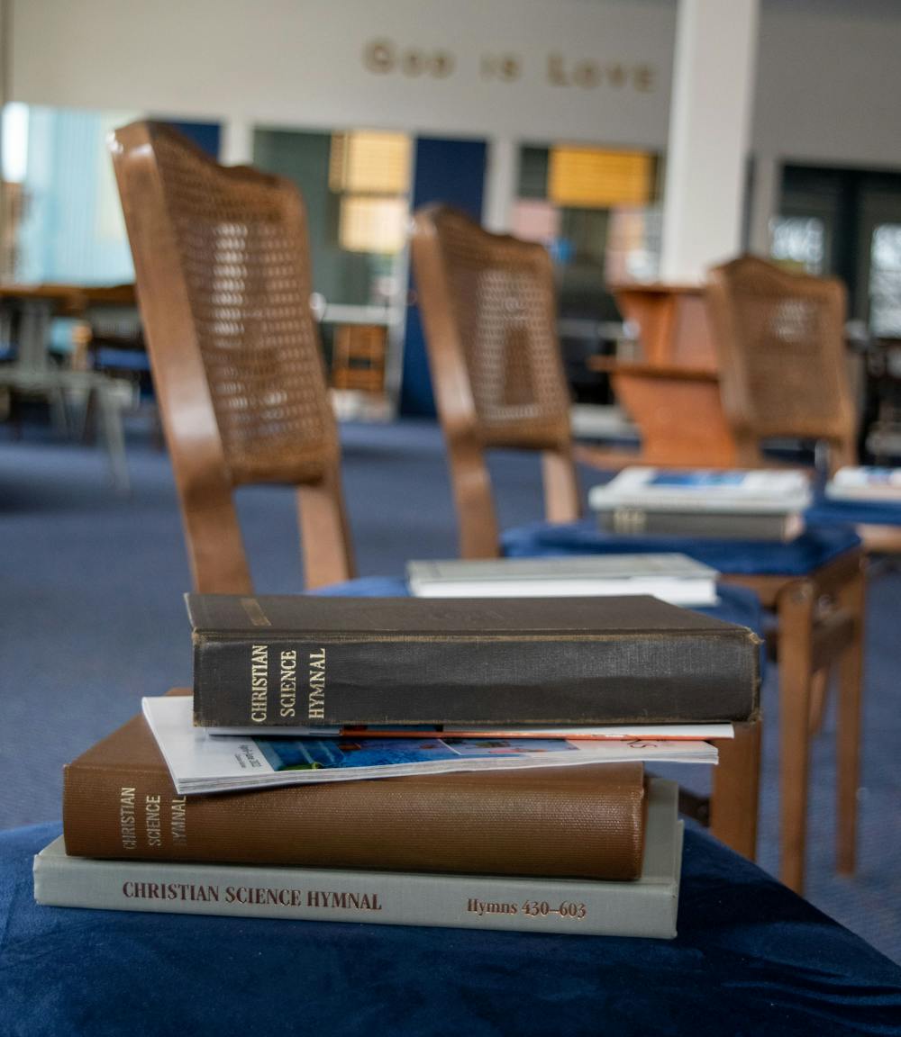 In the Christian Science church's sunday school the chairs are set in a circle around a podium on April 18, 2022. All the chairs have the Christian Science Hymnal placed on top of them for students. 