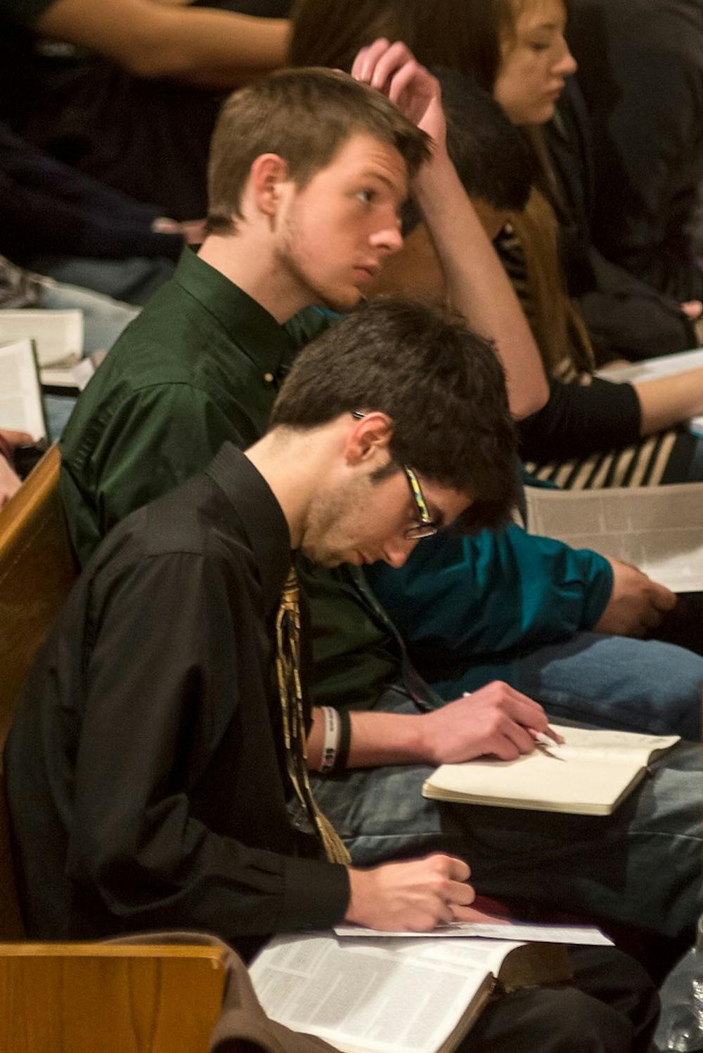 <p>Human biology senior David Groendyk, front, and crop and soil science junior Ben VanDyke attend a service Feb. 23, 2014, at the University Reformed Church. A shuttle going between campus and the church is available for students before and after Sunday service. Casey Hull/The State News</p>