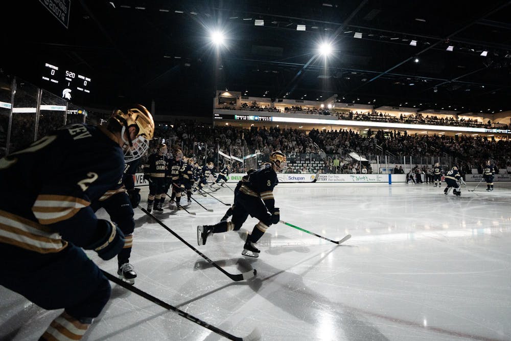 The Notre Dame hockey team skates to the center of the rink after the pregame introduction at Munn Ice Arena on March 15, 2025. The Spartans took a 1-0 victory over the Fighting Irish, advancing to the Big Ten Championship.