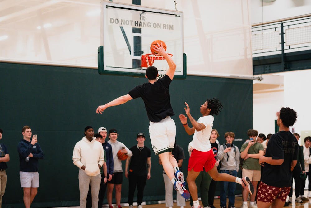 <p>Michigan State senior forward Frankie Fidler dunks the ball at IM East on April 16, 2025. The men's basketball team showed off their skills during pickup runs for students to watch.</p>