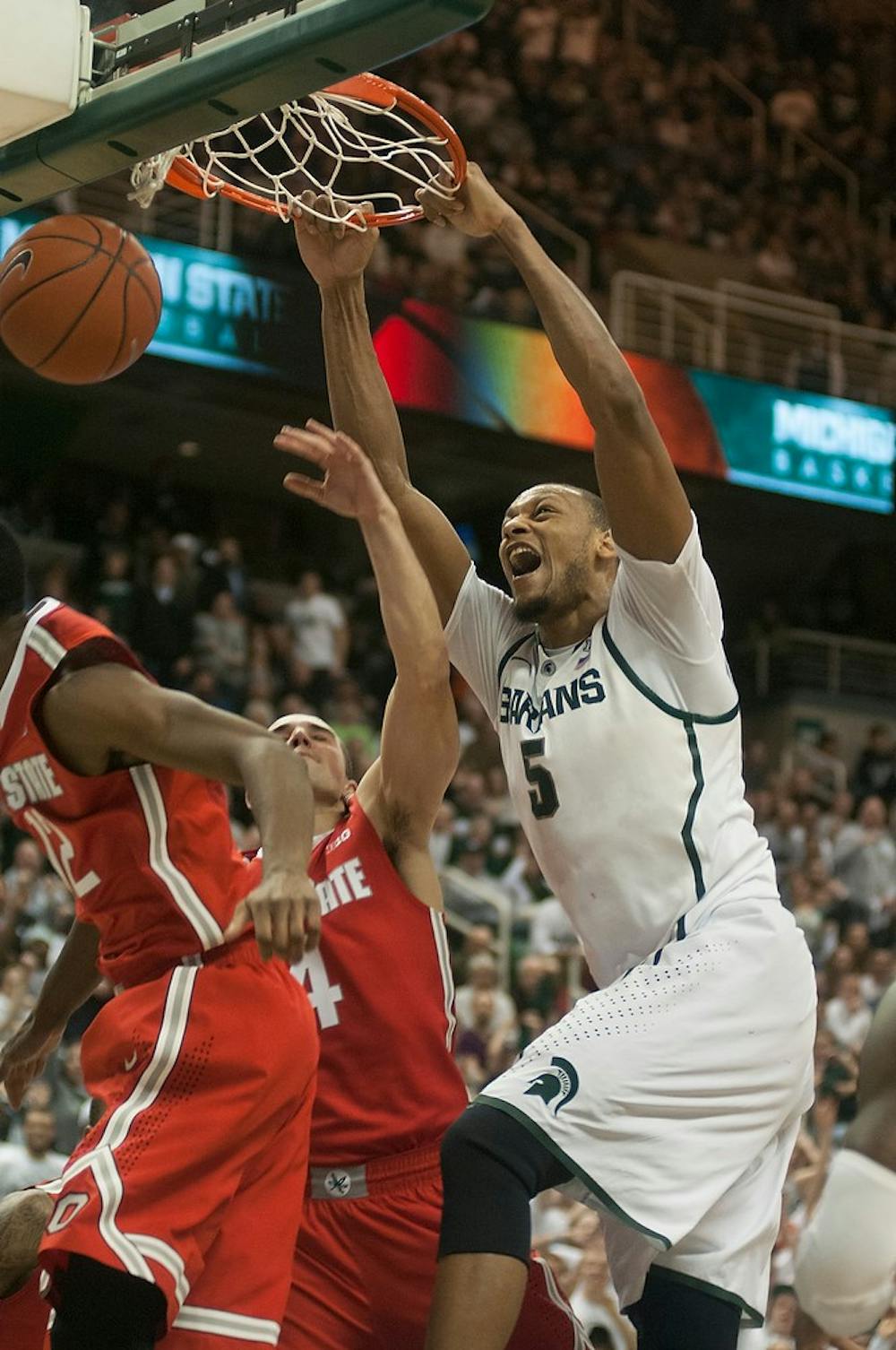 	<p>Senior center Adreian Payne dunks the ball over Ohio State players Jan. 7, 2014, at Breslin Center. The Spartans defeated the Buckeyes in overtime, 72-68. Danyelle Morrow/The State News</p>