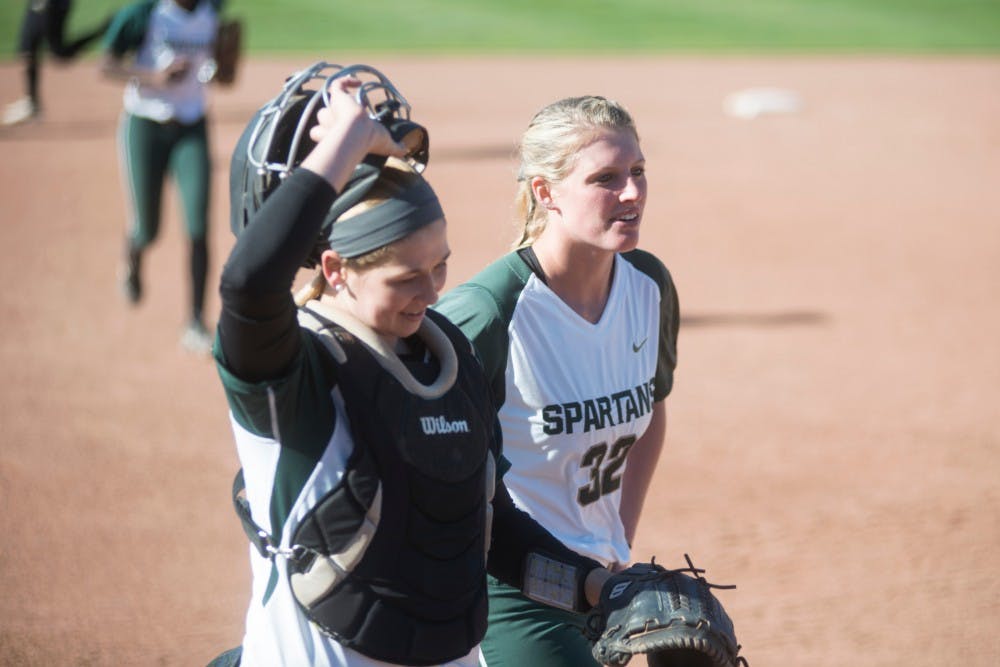 Sophomore Bridgette Rainey, right, and sophomore catcher Jordan Davis walk to the dugout during the game against Broncos on March 29, 2016 at Secchia Softball Stadium. The Spartans defeated the Western Broncos, 12-2.