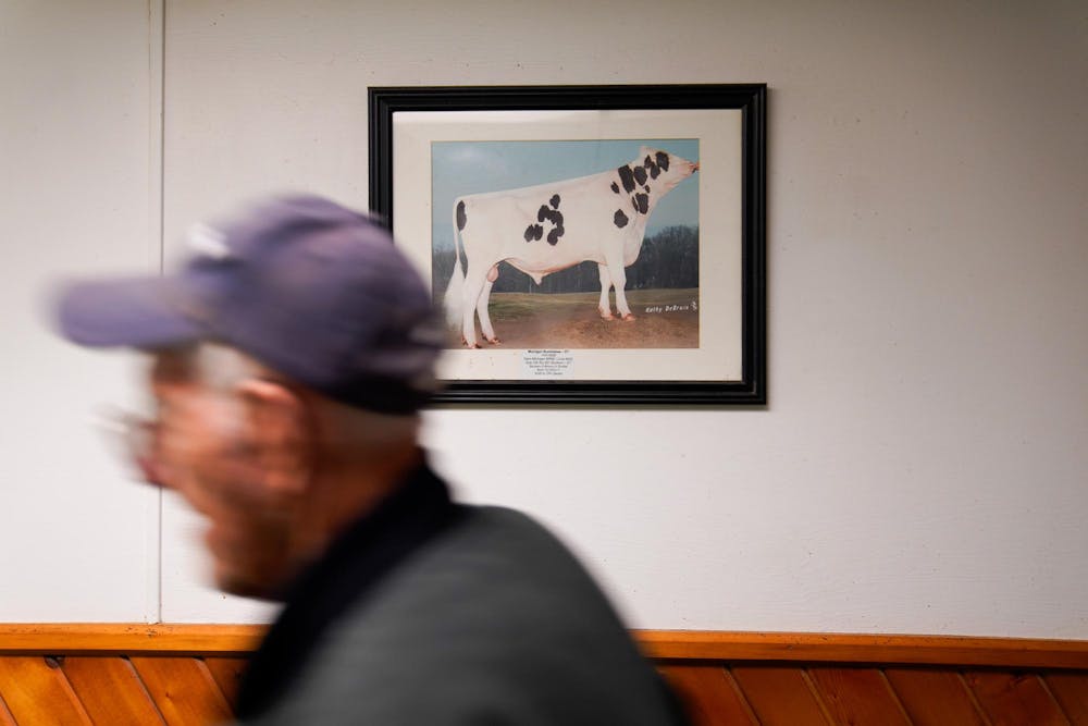 <p>Duane Reum, 88, of Lansing, moves through the Dairy Cattle and Research Center at the end of his shift on Sept. 28, 2023.</p>