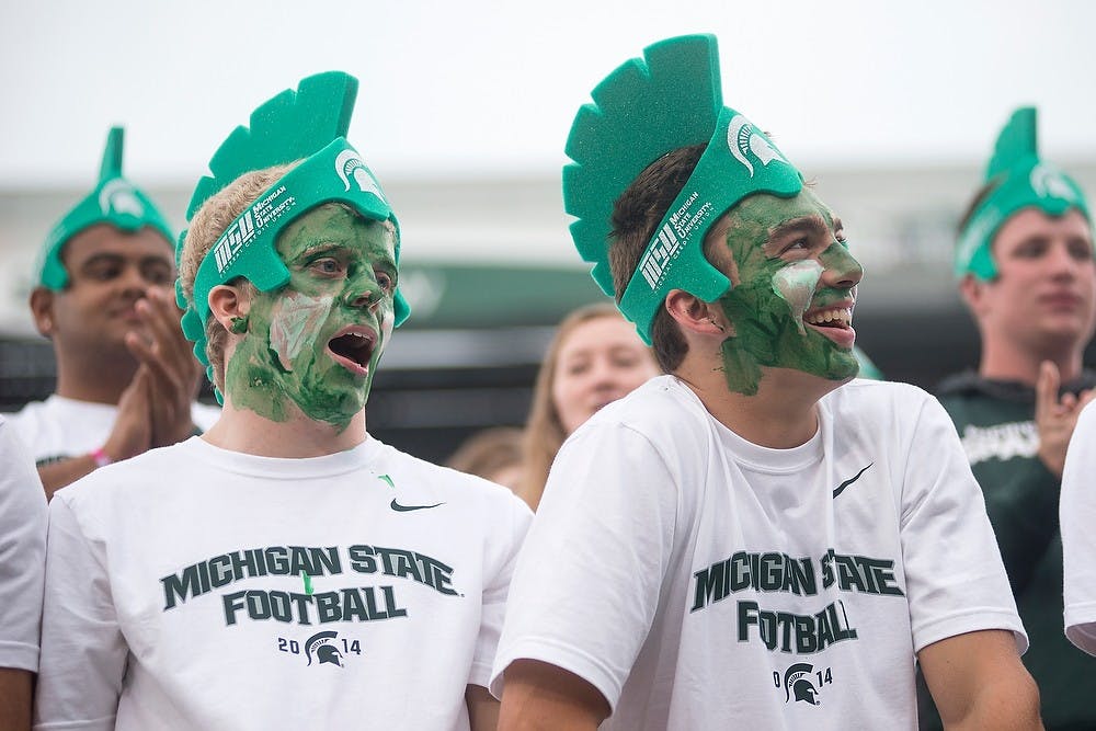 <p>Members of the student section watch the video board during a game against Jacksonville State on Aug. 29, 2014, at Spartan Stadium. Julia Nagy/The State News</p>