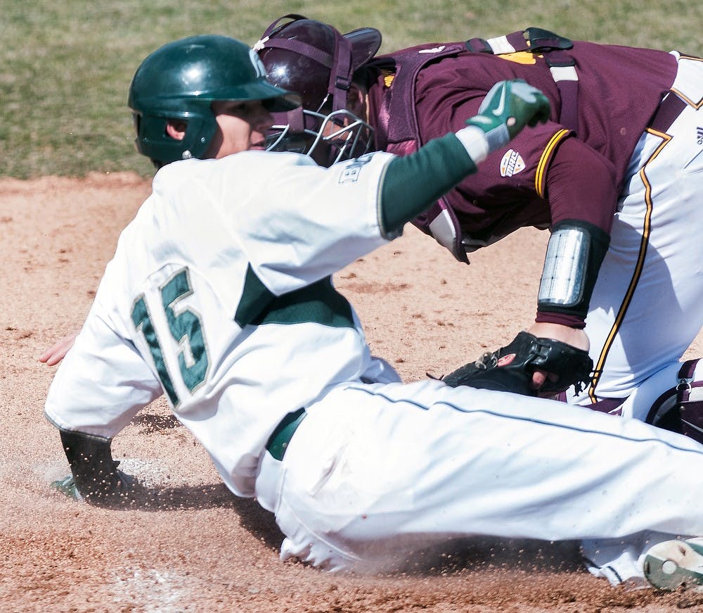 	<p>Sophomore outfielder Anthony Cheky slides into home base after a hit against Central Michigan on Tuesday, April 2, 2013, during the <span class="caps">MSU</span> home opener. <span class="caps">MSU</span> beat <span class="caps">CMU</span> 4-2, and is due to play Michigan during the next home game on Friday, April 5, 2013. Danyelle Morrow/The State News</p>