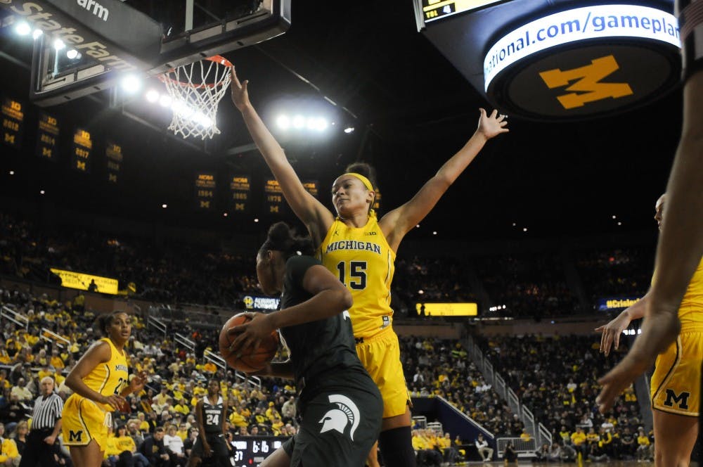 <p>U-M's sophomore forward Hailey Brown (15) guards Spartan sophomore forward Sidney Cooks (10) on Jan. 27, 2019 at the Crisler Arena. The Spartans defeated the Wolverines 77-73.&nbsp;</p>