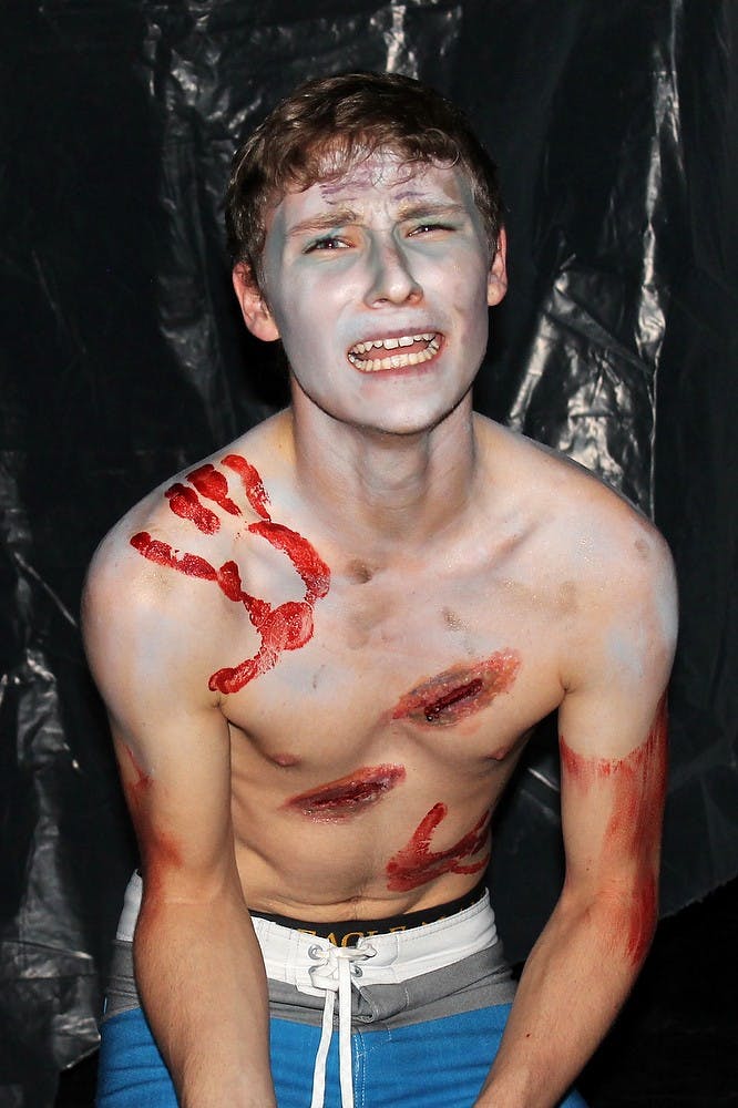 <p>Theatre freshman Jacob Covert acts during a Haunted Aud dress rehearsal on Oct. 28, 2014, at the Auditorium. The Haunted Aud features over one hundred and twenty student actors this year. Jessalyn Tamez/The State News </p>