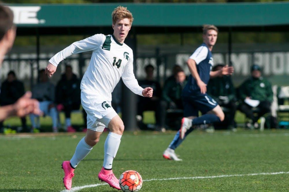 <p>Then-junior midfielder Dewey Lewis looks to pass during the Men's Soccer game against Penn State on Oct. 18, 2015, at the DeMartin Soccer Complex. The Spartans defeated the Nittany Lions, 2-1.</p>