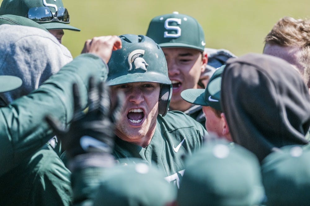 Sophomore pinch runner Danny Gleaves (1) celebrates with his team after scoring the go ahead run on a passed ball during the game against Nebraska on April 8, 2018. The Spartans defeated the Cornhuskers, 5-3. (C.J. Weiss | The State News)