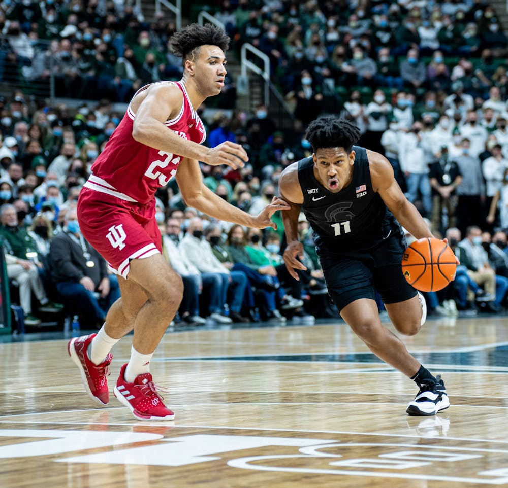 <p>Michigan State sophomore guard A.J. Hoggard (11) dribbles the ball past Indiana&#x27;s junior forward Trayce Jackson-Davis (23) during Michigan State&#x27;s victory over Indiana on Feb. 12, 2022.</p>