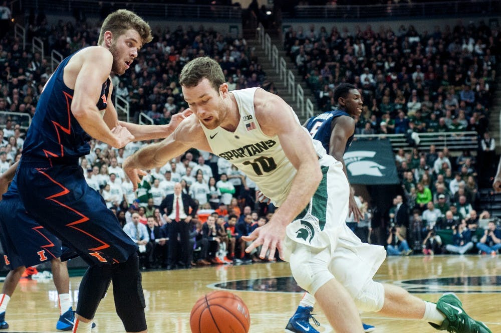 Senior forward Matt Costello fights past Illinois forward Michael Finke during the second half of the game against Illinois on Jan. 7, 2016 at Breslin Center. The Spartans defeated the Illini, 79-54. 