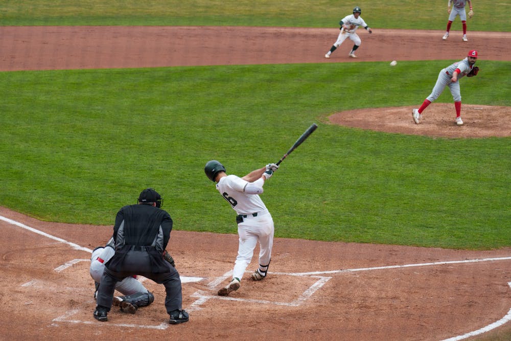 <p>Michigan State redshirt junior Peter Ahn smashes the ball and runs to first on March 30, 2022. Spartans are victorious 12-5 against Youngtown State.</p>