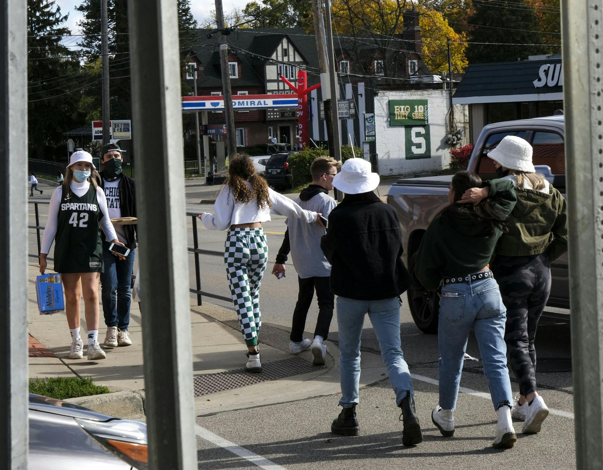 Green and white adorning MSU football fans roaming the streets during MSU's first football game among Coronavirus conditions on October 24, 2020.