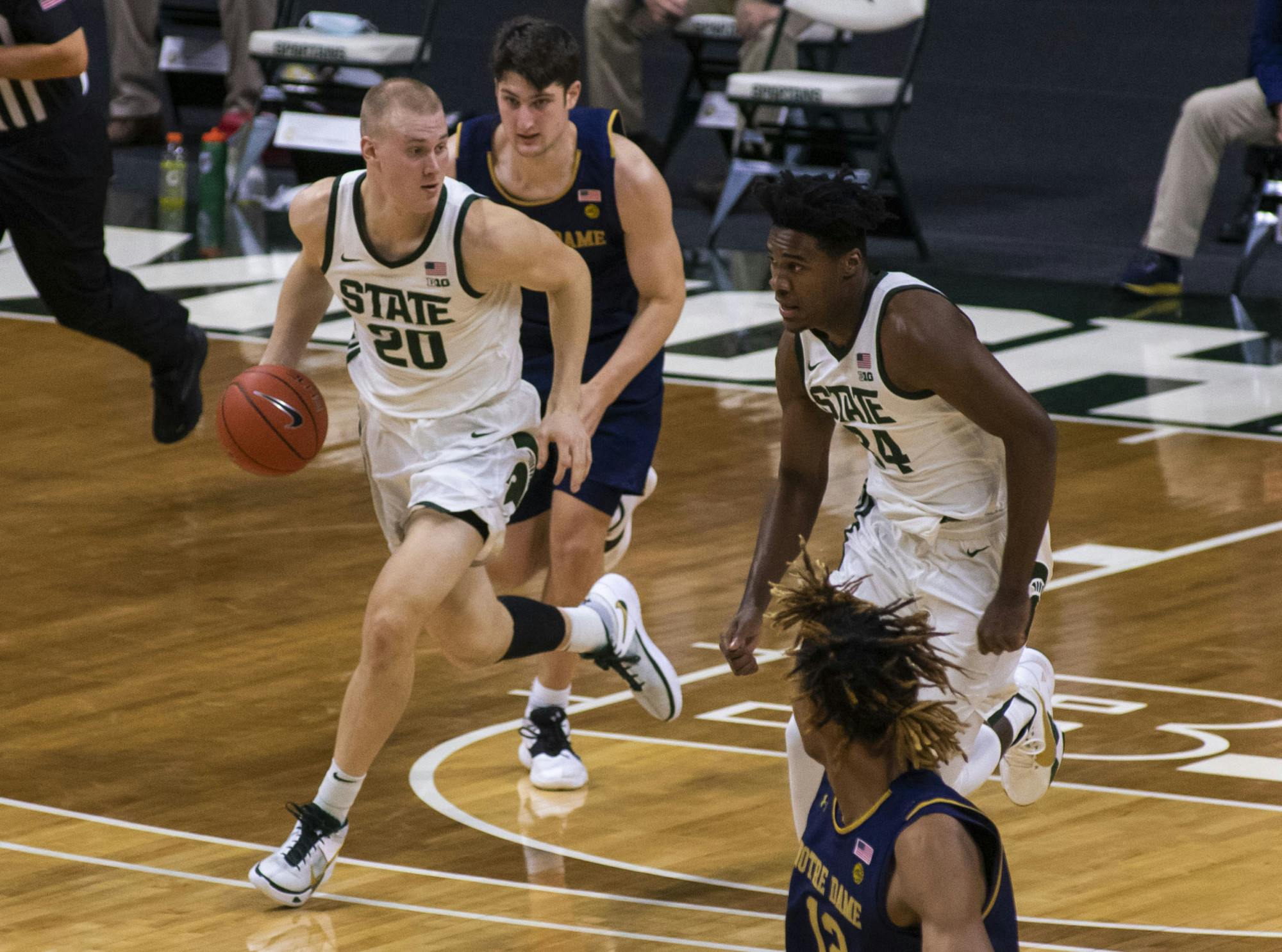 Redshirt-junior forward Joey Hauser (2) communicates with his teammate, sophomore forward Julius Marble II (34), during the second half of the game. Michigan State triumphed over Notre Dame, 80-70, on Nov. 28, 2020. 