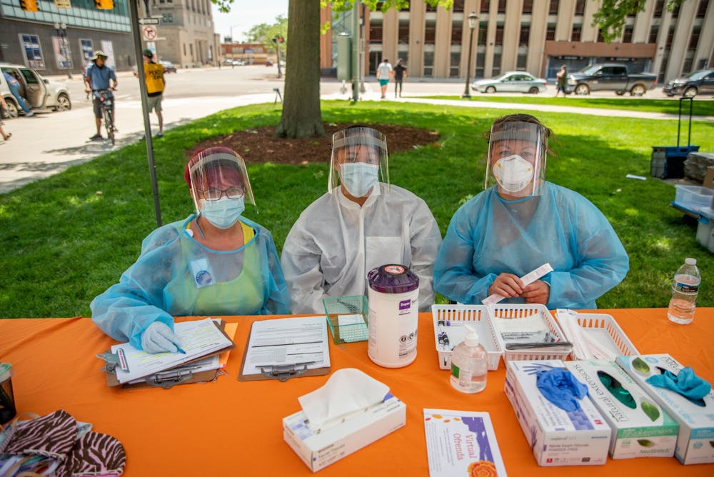 Angie Boughner, Kisha Nason and Michelle Curtin (right to left) pose for a photo in between testing patients at the COVID-19 testing tent at the BLM rally at the Capitol June 29, 2020.