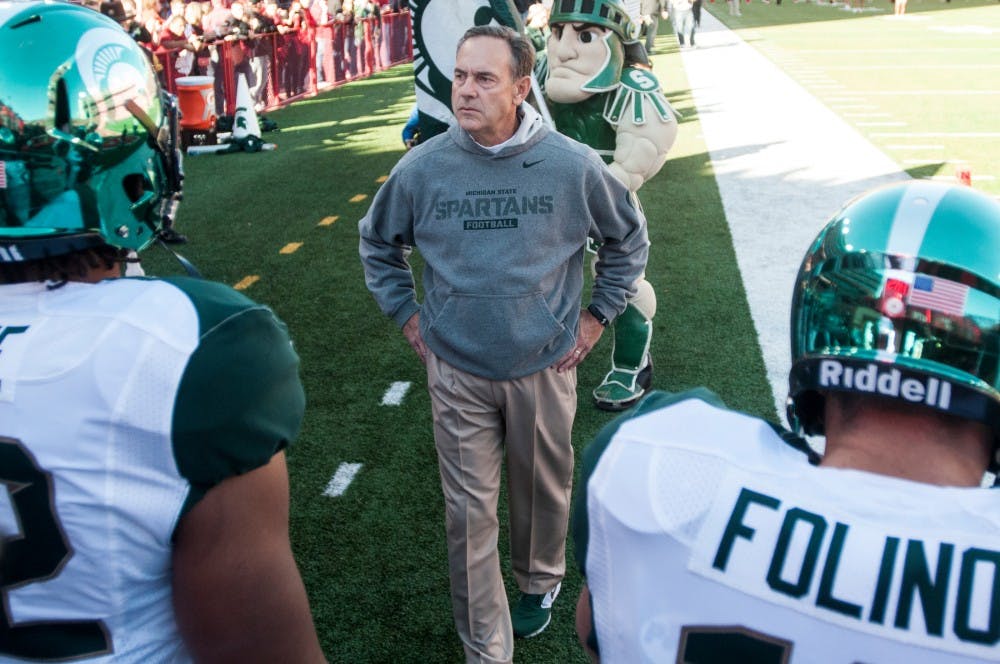 	<p>Head coach Mark Dantonio prepares to head onto the field before the game against Nebraska on Nov. 16, 2013, at Memorial Stadium in Lincoln, Neb. The Spartans defeated the Cornhuskers, 41-28. Khoa Nguyen/The State News</p>