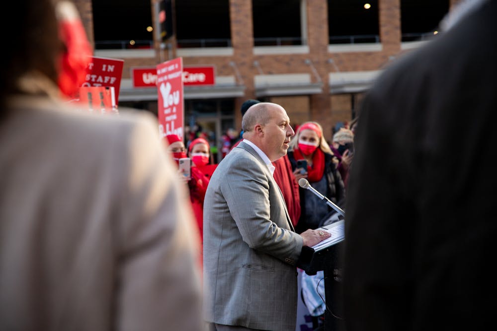 <p>Sparrow nurses along with supporters of them picket along Michigan Avenue in Lansing on Nov. 3, 2021. Shown is state Sen. Curtis Hertel speaking at the event.</p>