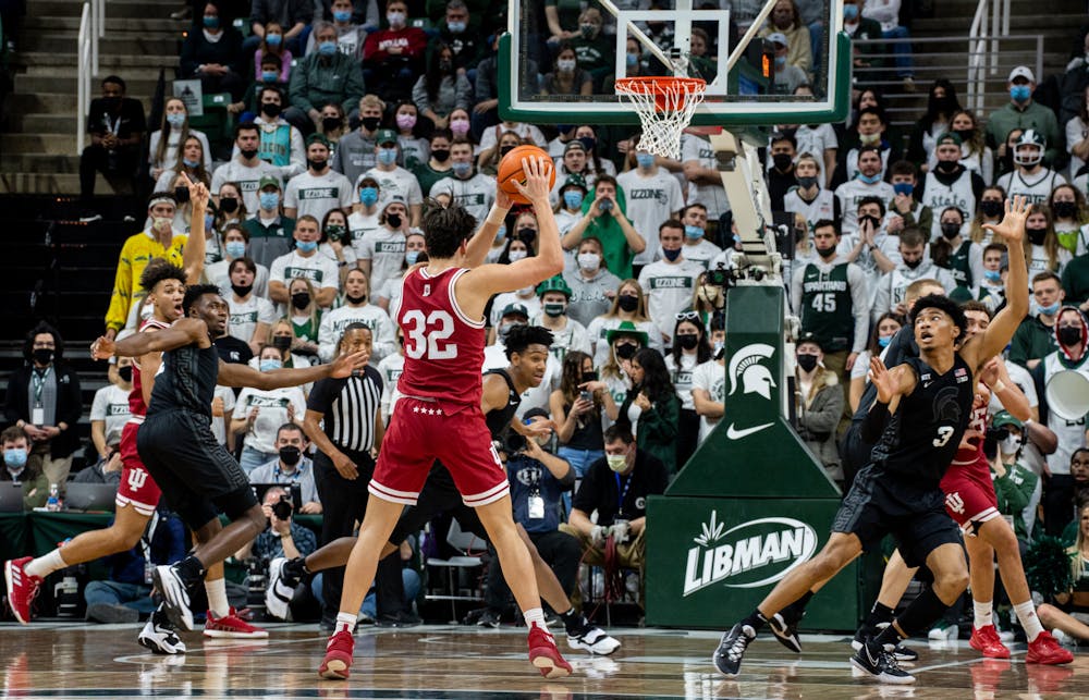 <p>The Spartans scramble to block a pass from Indiana sophomore guard Trey Galloway (32) during Michigan State&#x27;s victory over Indiana on Feb. 12, 2022.</p>