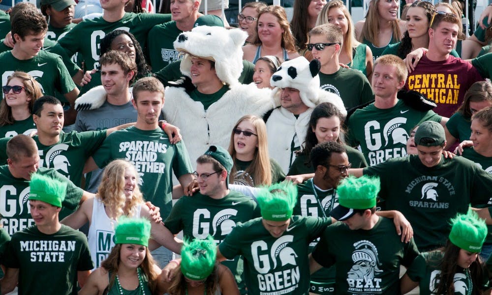 <p>Spanish and kinesiology senior David Berkompas, in the polar bear suit, and advertising senior David Weston, in the panda suit, join the student section in the singing of "MSU Shadows" before the game against Central Michigan on Sept. 26, 2015, at Spartan Stadium. The Spartans defeated the Chippewas, 30-10.</p>