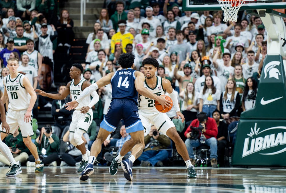 Senior forward Malik Hall (25) guards opponent graduate student guard Caleb Daniels (14) during a game against Villanova at the Breslin Center on Nov. 18, 2022. The Spartans defeated the Wildcats 73-71. 